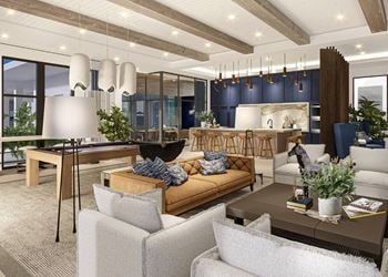 Clubhouse with couches and chairs and a kitchen